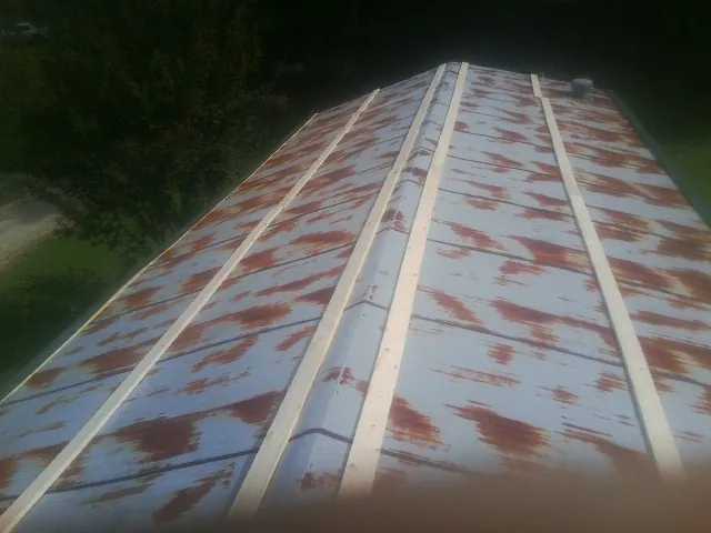 Rusted metal roof panels with new wood purlins before replacement — Storm Damage Roof Repair in Fort Montgomery by Roofing Brothers
