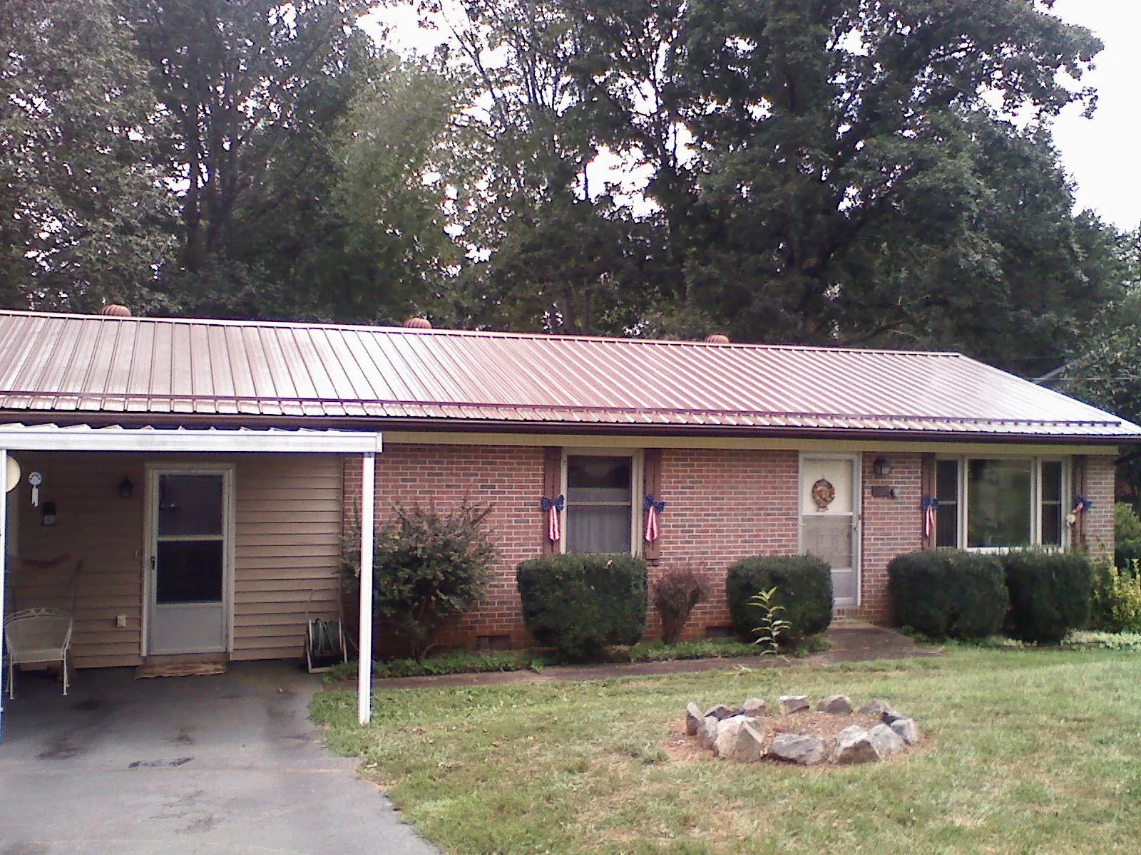Bronze metal roof and carport on a brick ranch home — Roof Repair work by our crew in Fort Montgomery